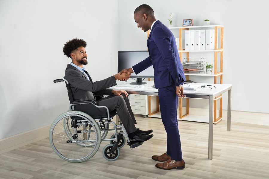 Person in Wheelchair Shaking Hands with Someone
